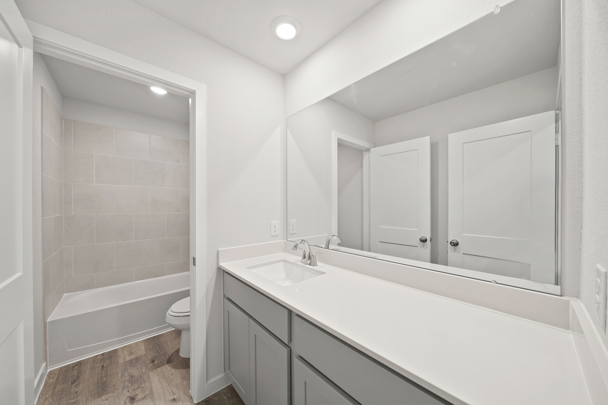A bathroom with a tub sink and toilet.