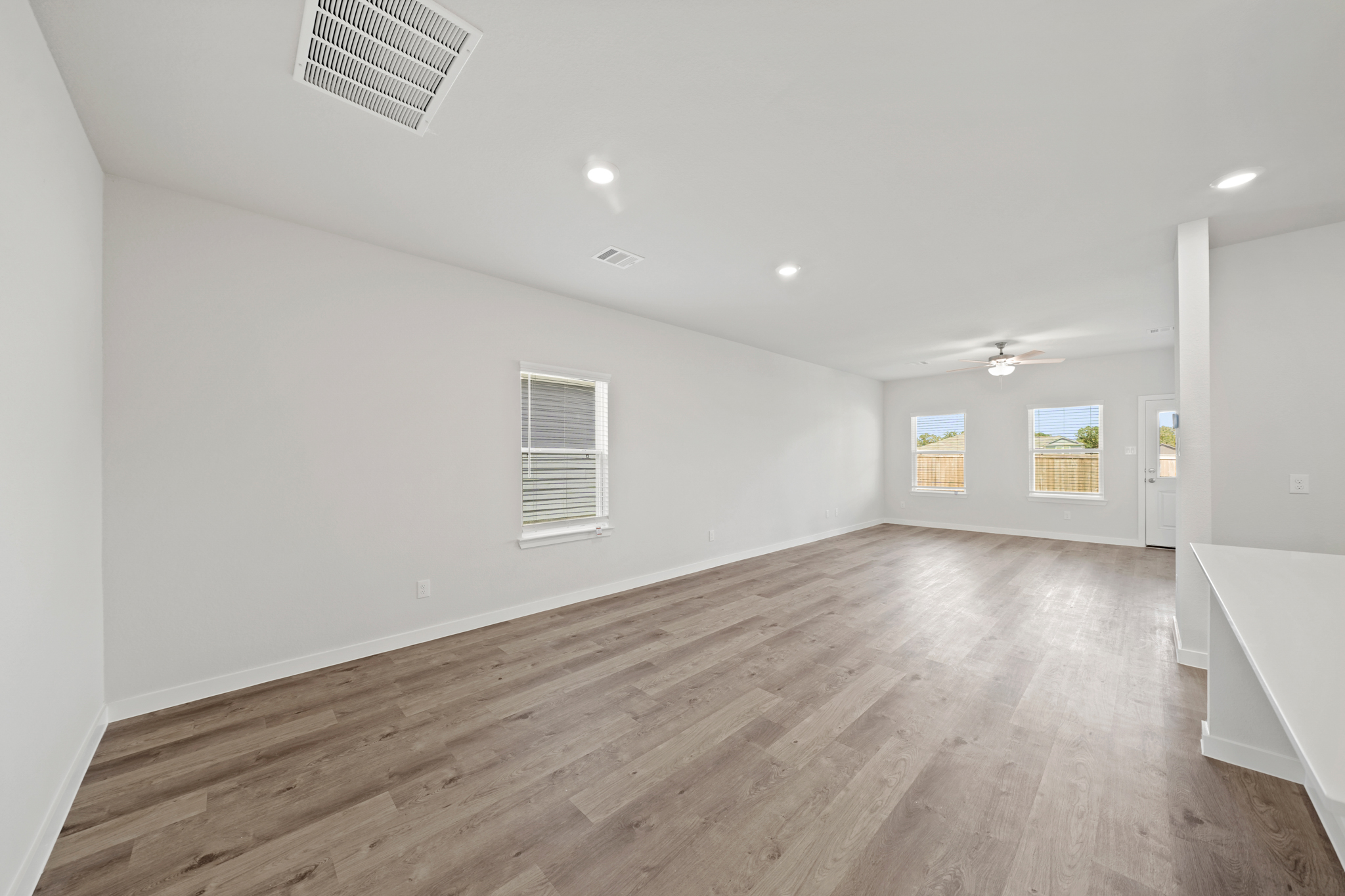 A room with a wood floor and white walls.