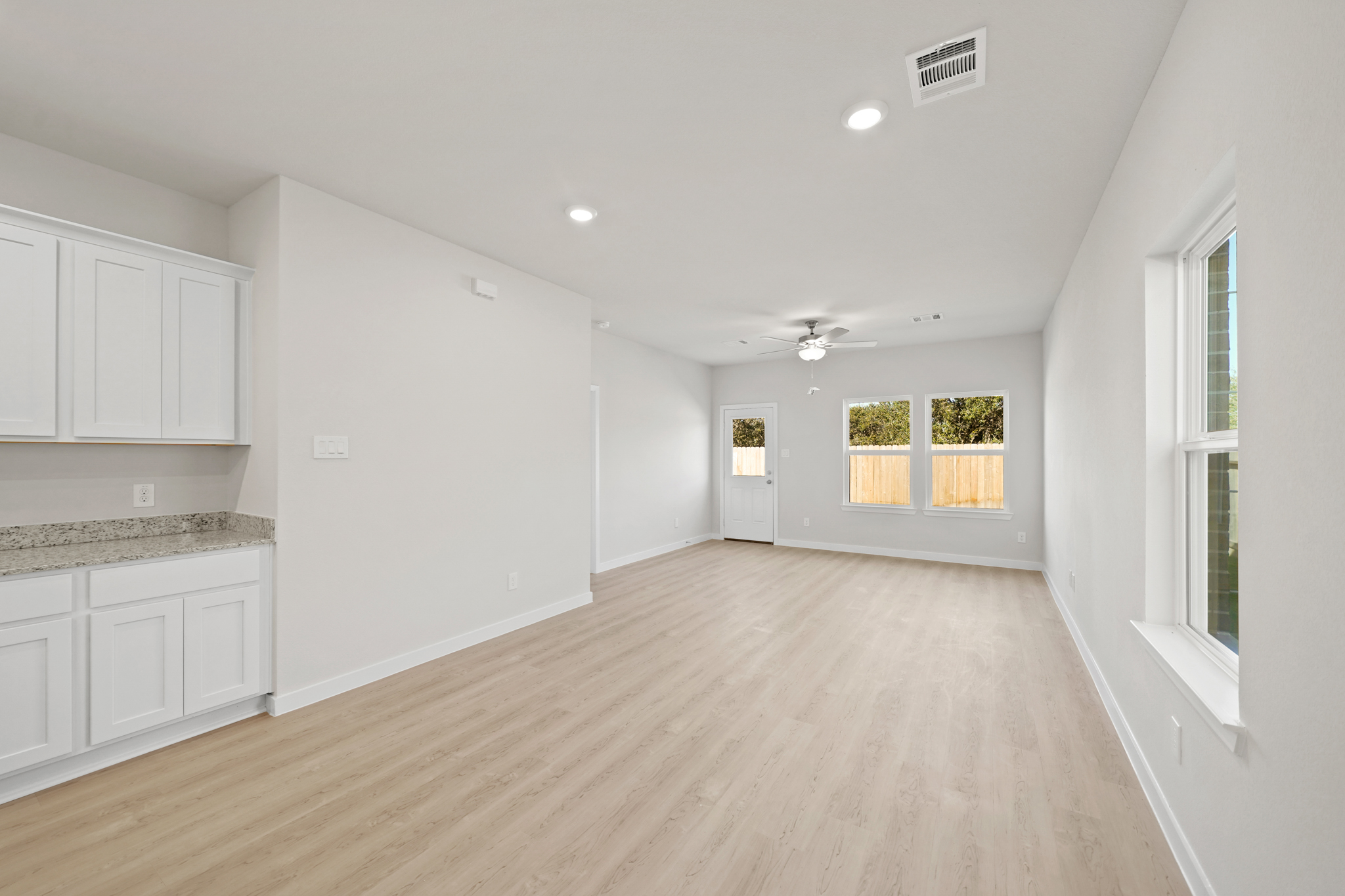 A large white kitchen with white cabinets.