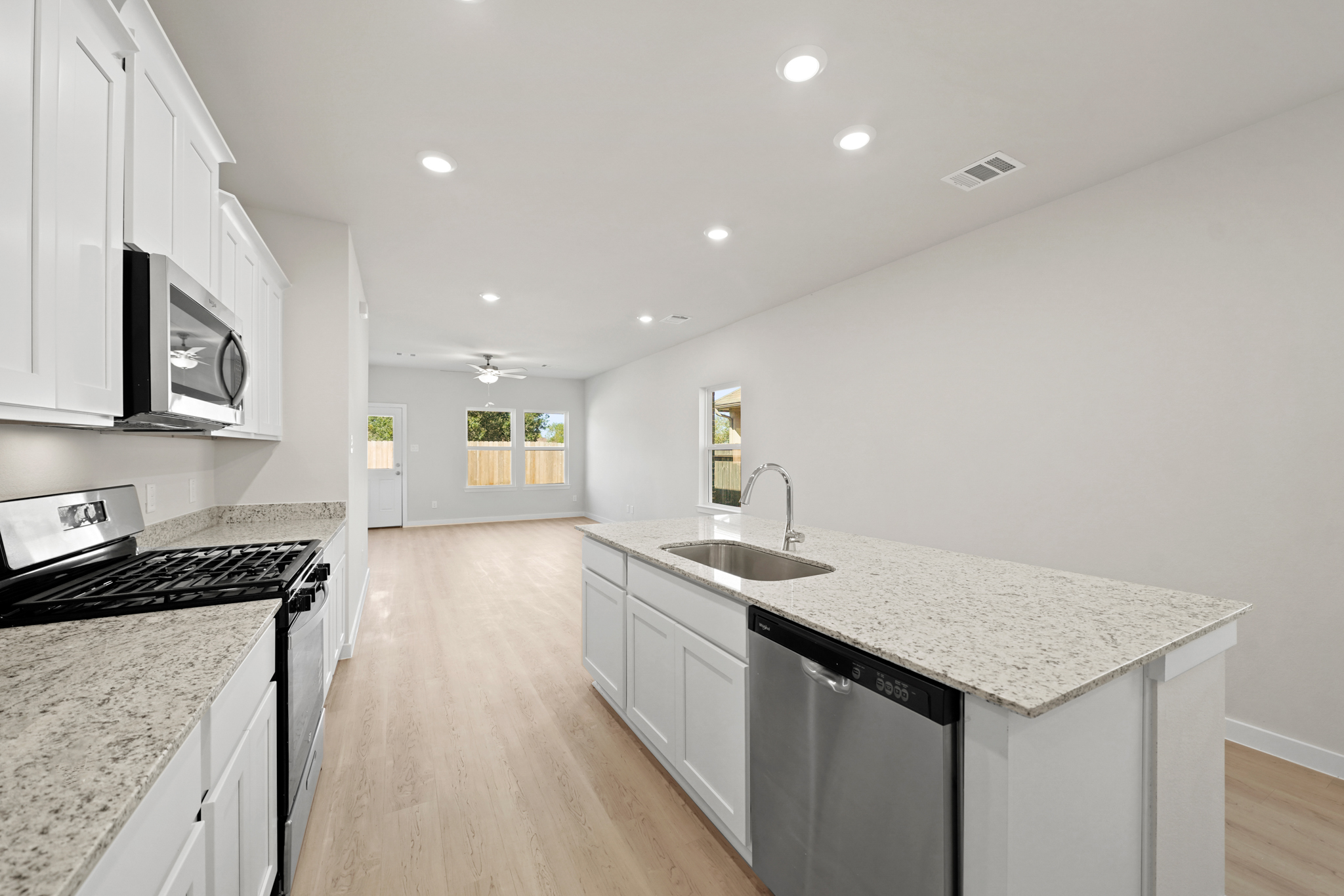 A kitchen with white cabinets.
