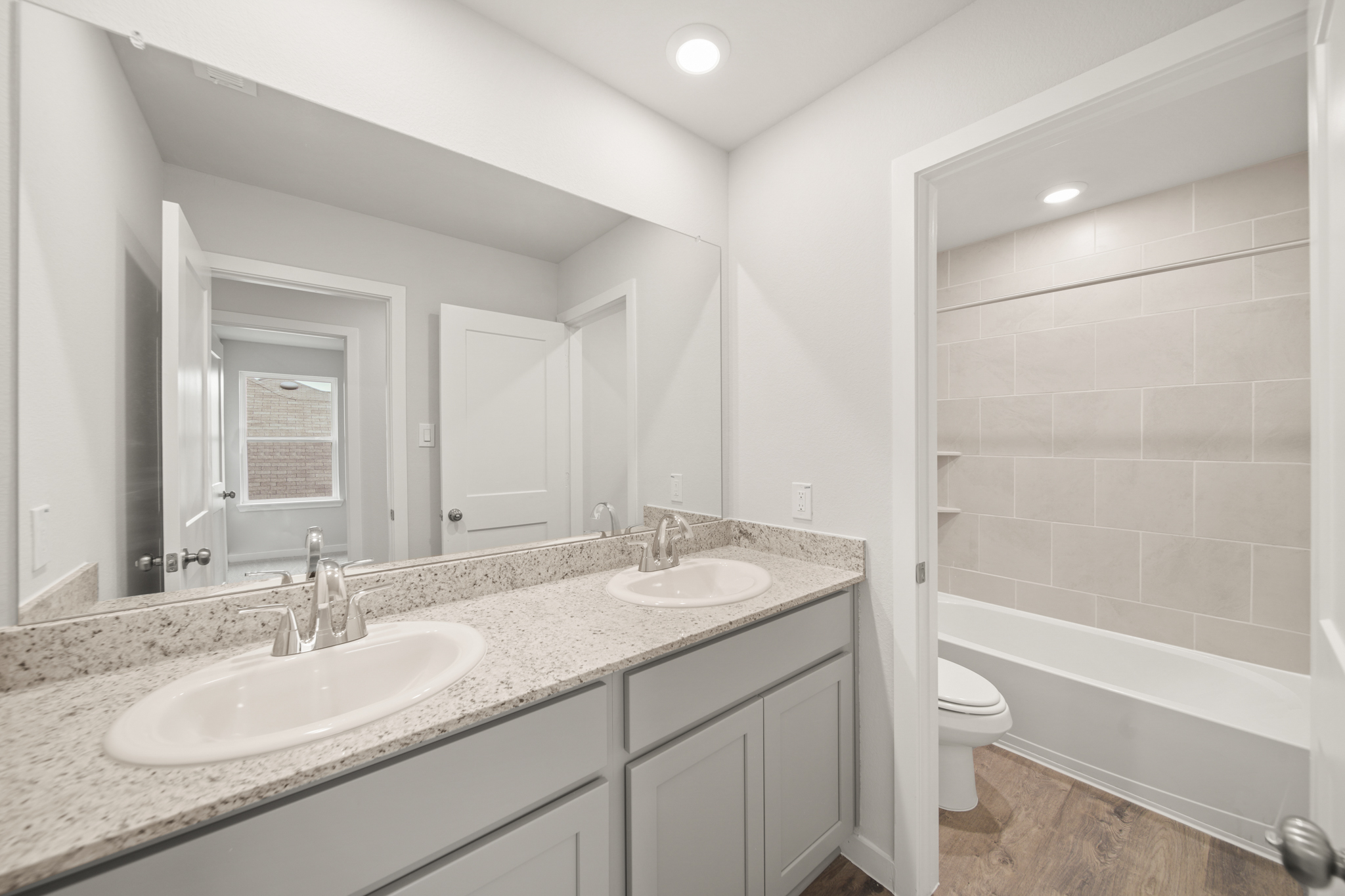 A bathroom with a tub sink and toilet.