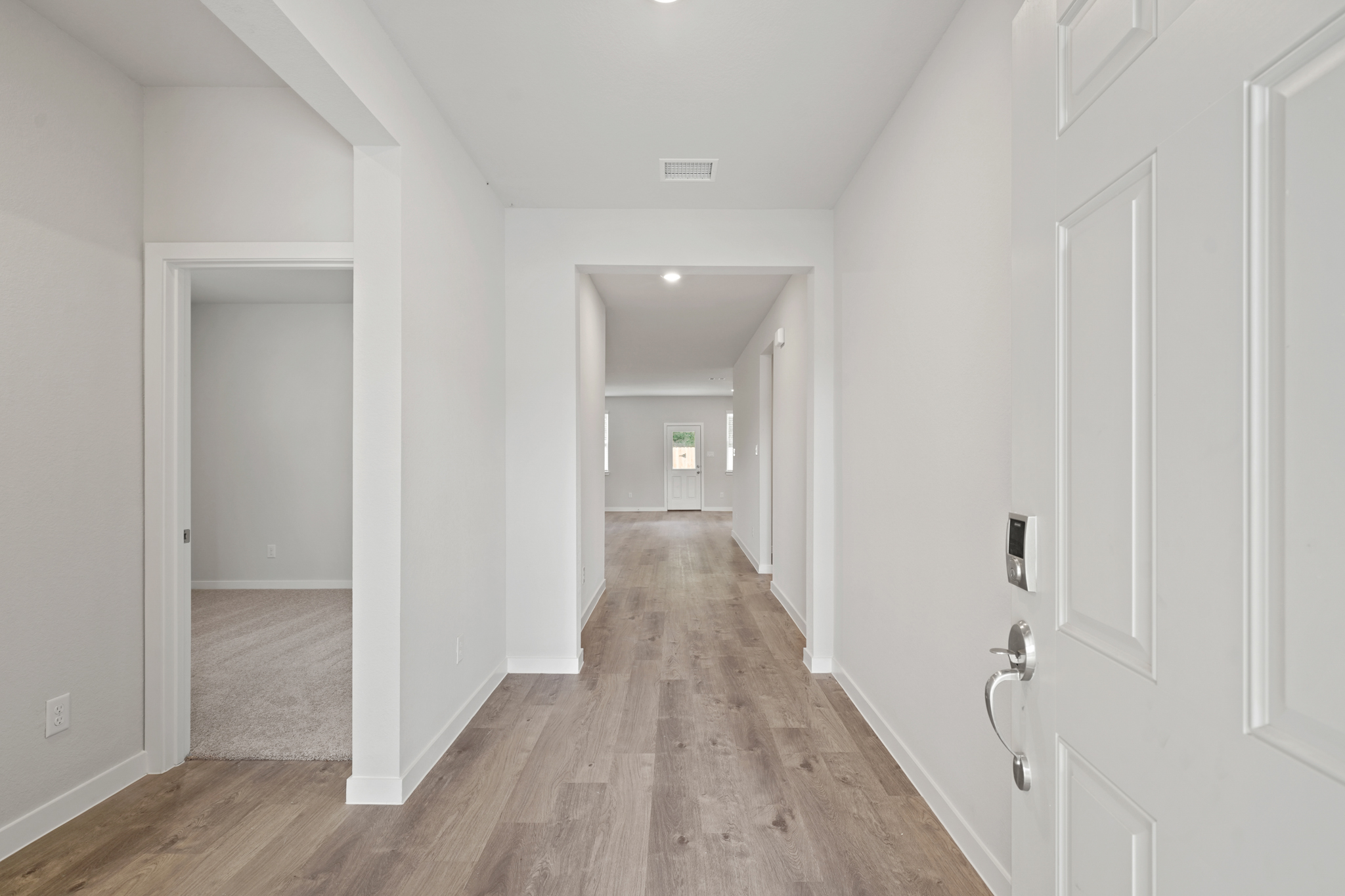 A hallway with white doors.