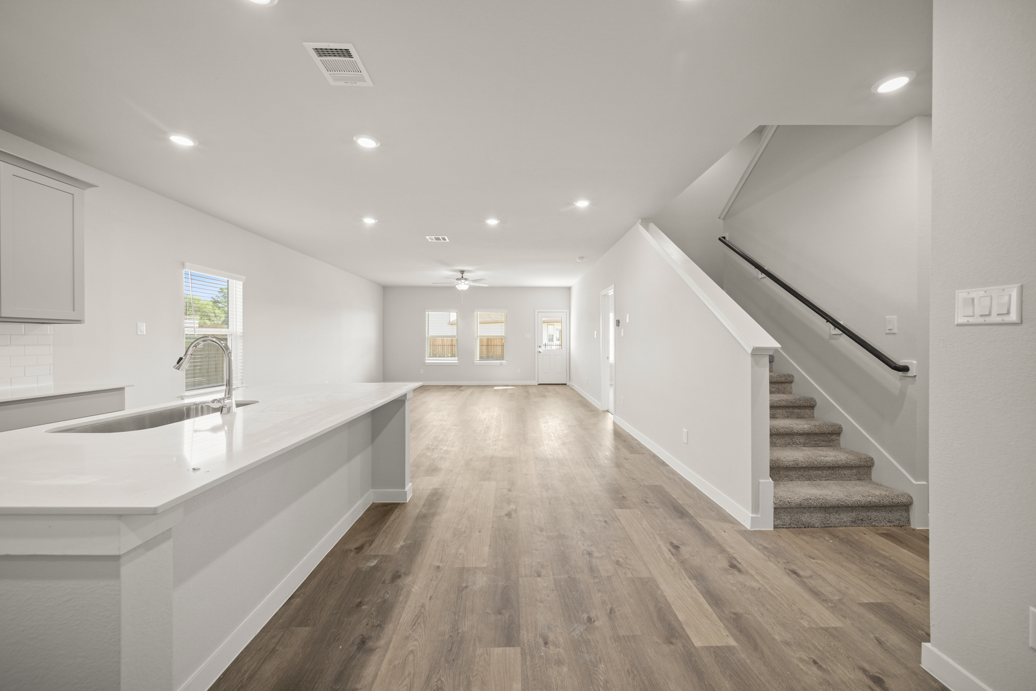 A large kitchen with white walls.