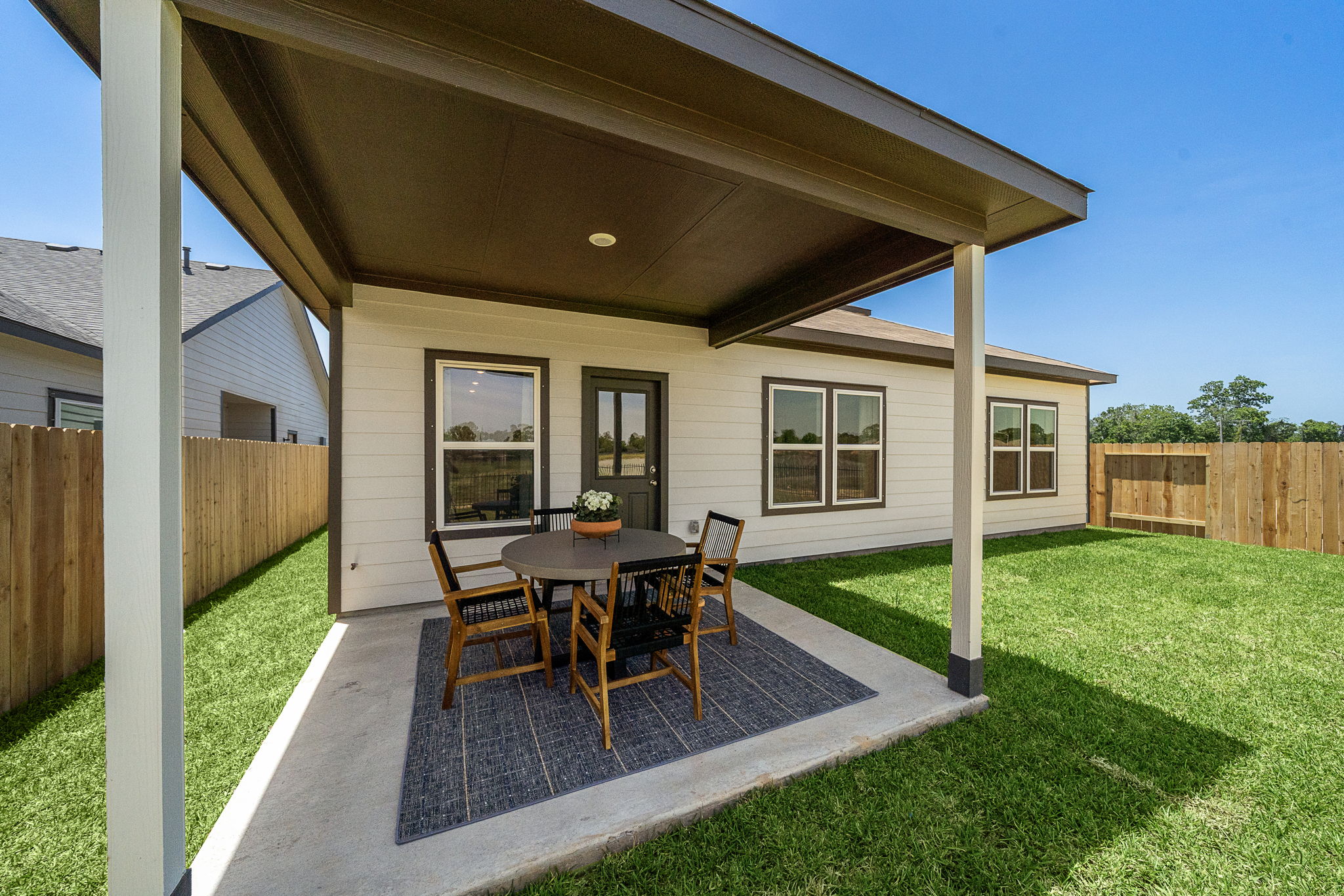 A house with a patio and a table and chairs.