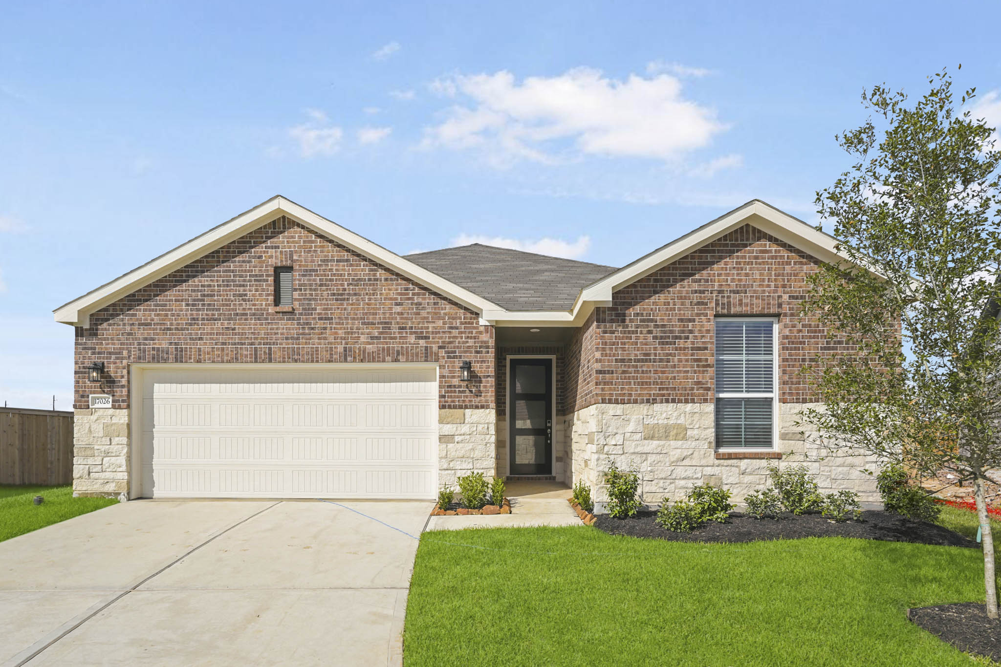 A brick house with a garage.
