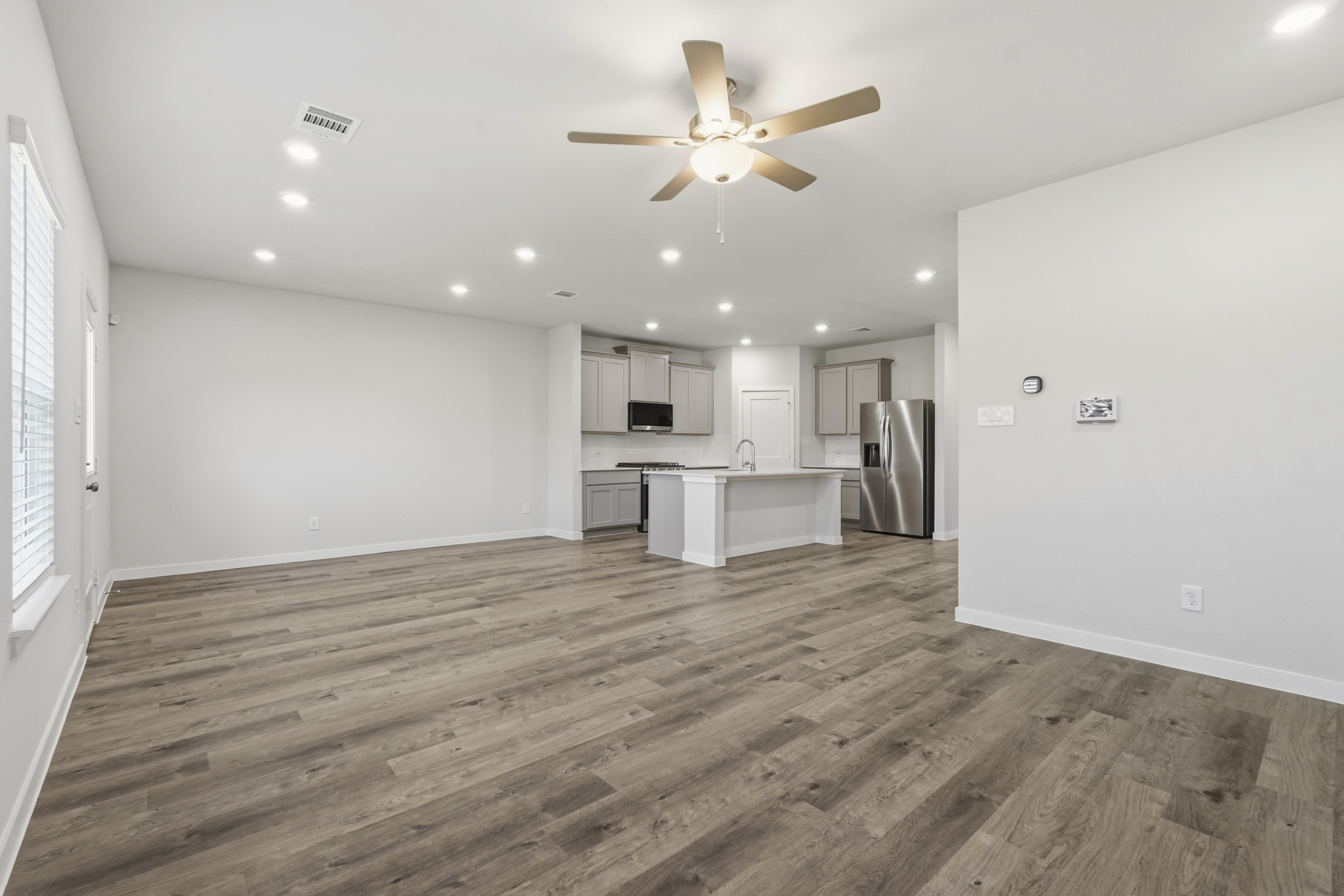 A kitchen with a wood floor.