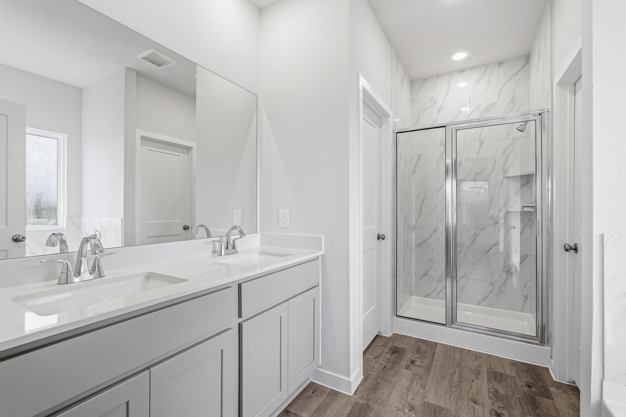 A bathroom with a glass shower.