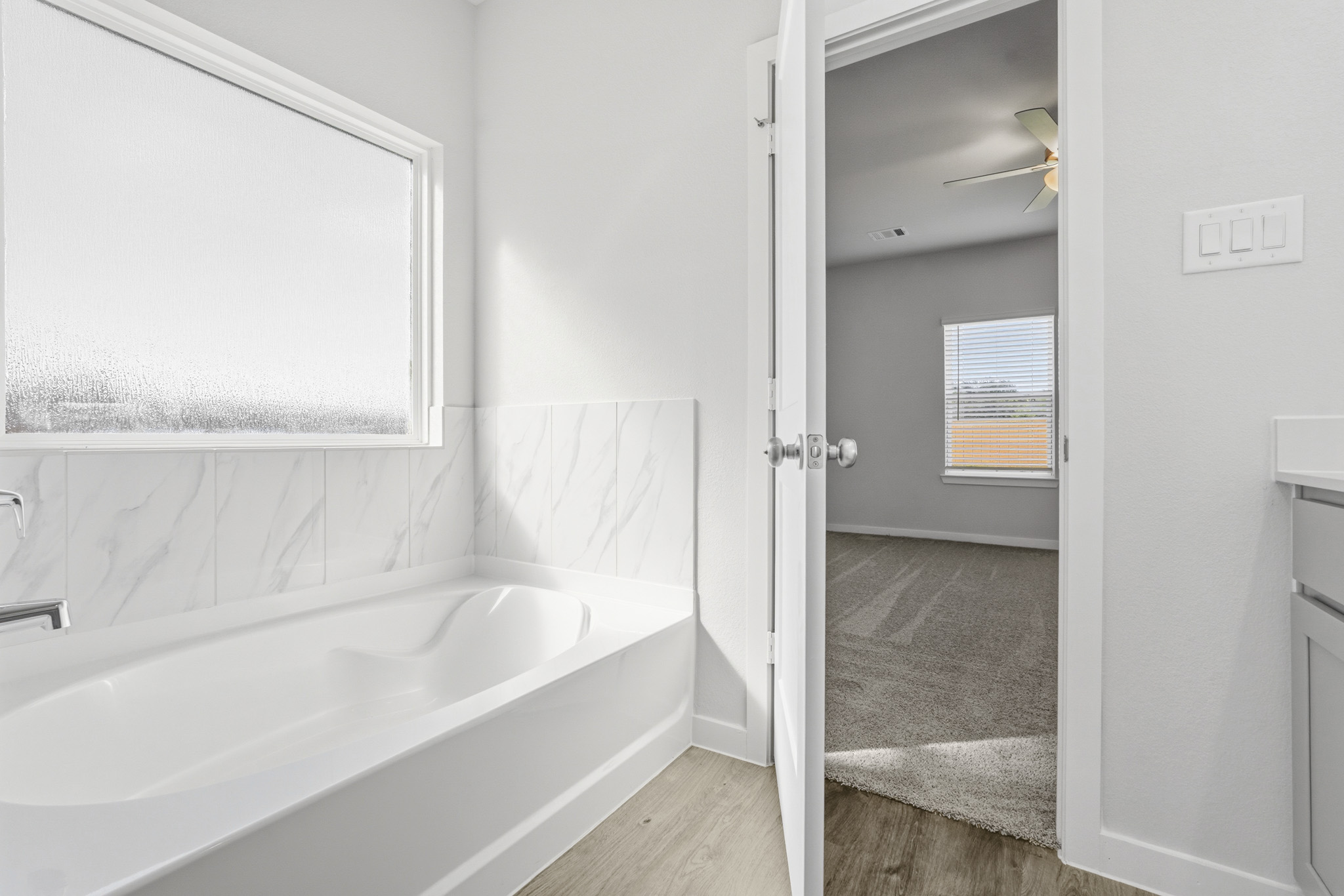 A bathroom with a bathtub and shower.
