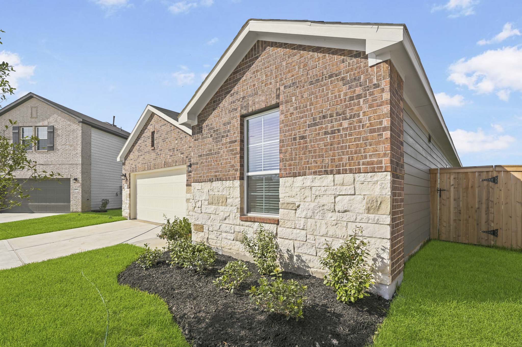 A brick house with a driveway.