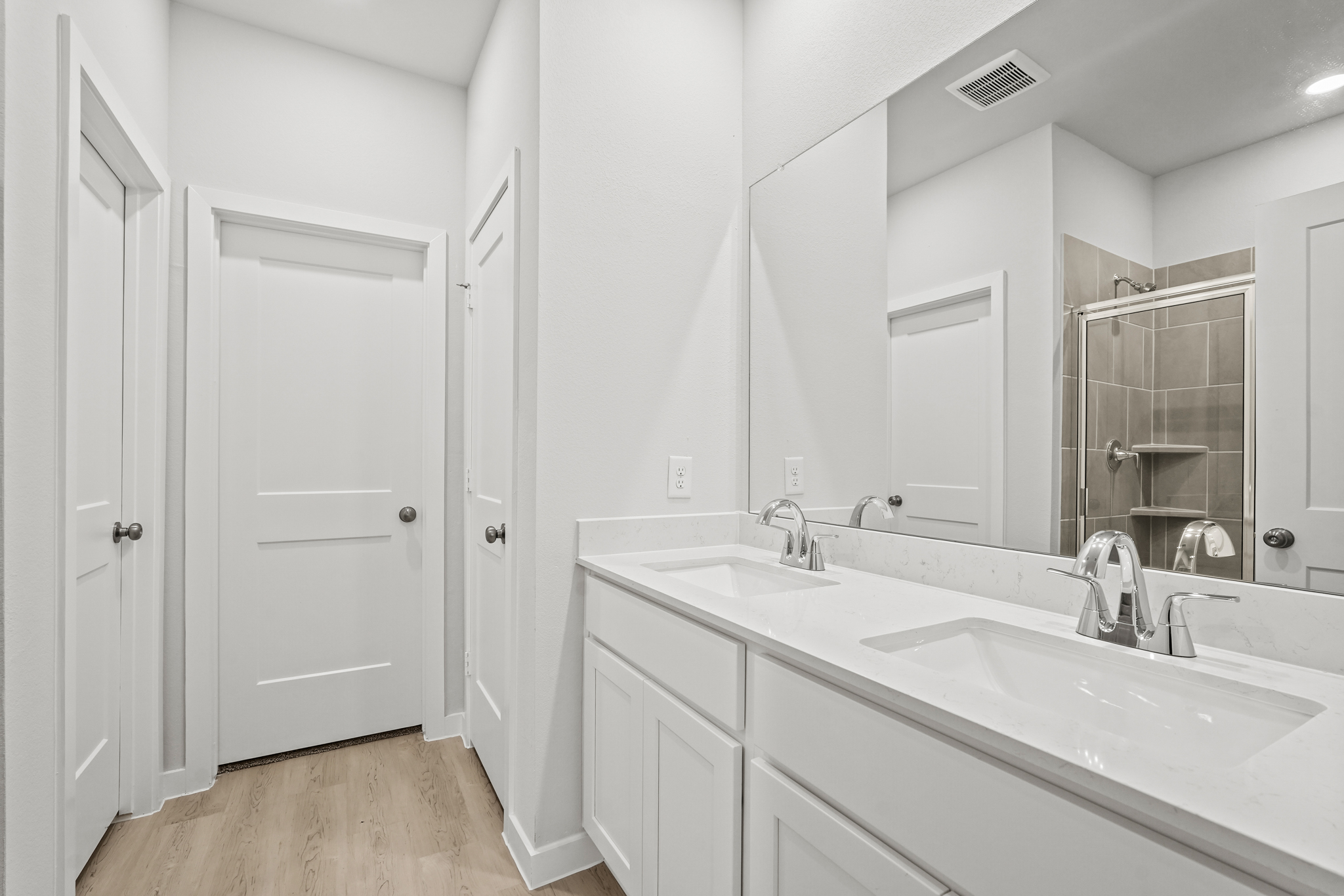 A bathroom with a large mirror.