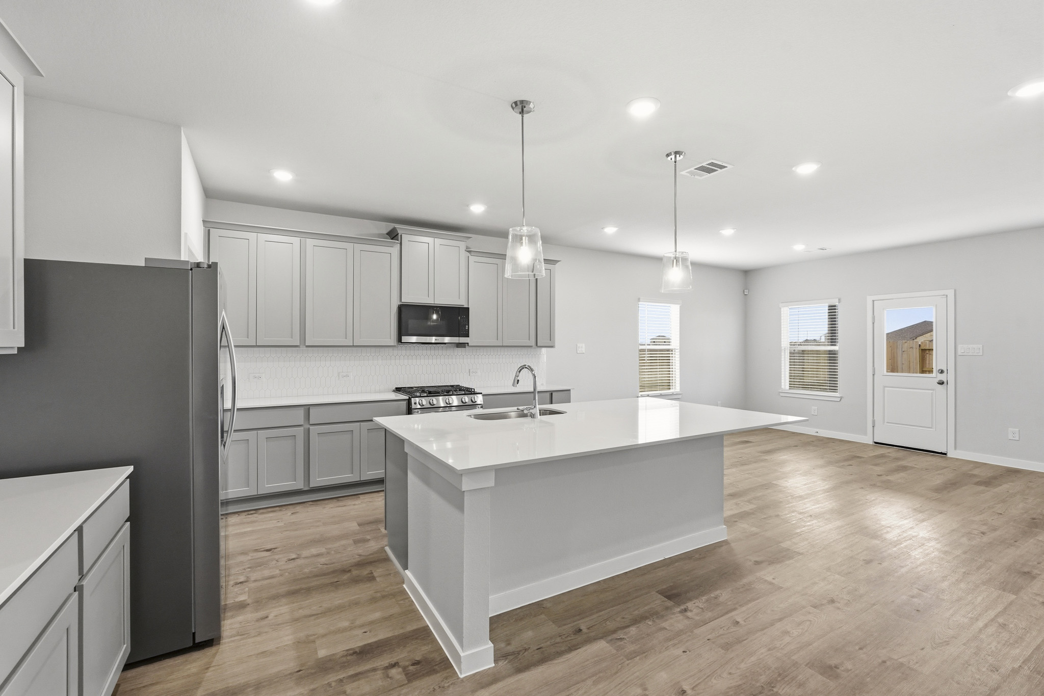 A kitchen with white cabinets.