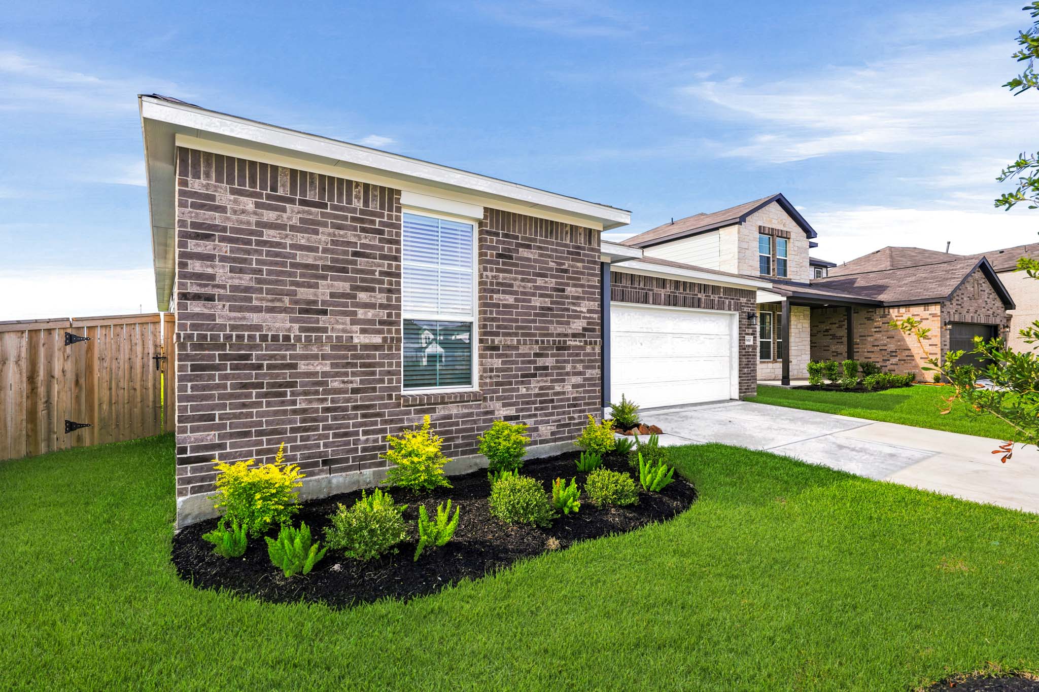 A brick house with a driveway.