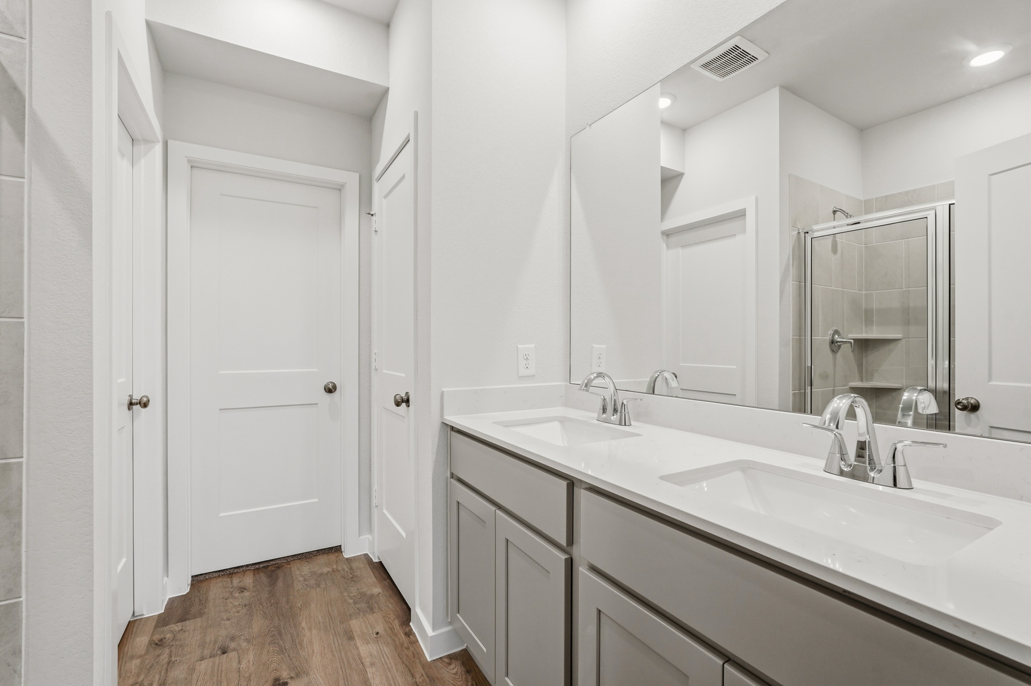 A bathroom with a large mirror.