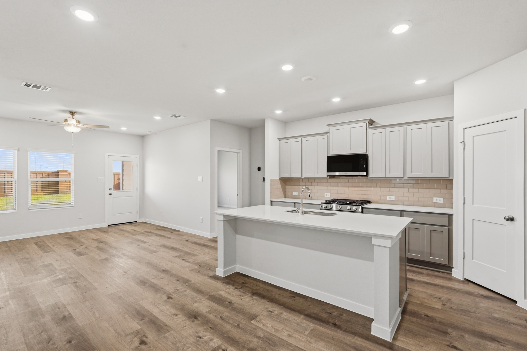 A kitchen with white cabinets.