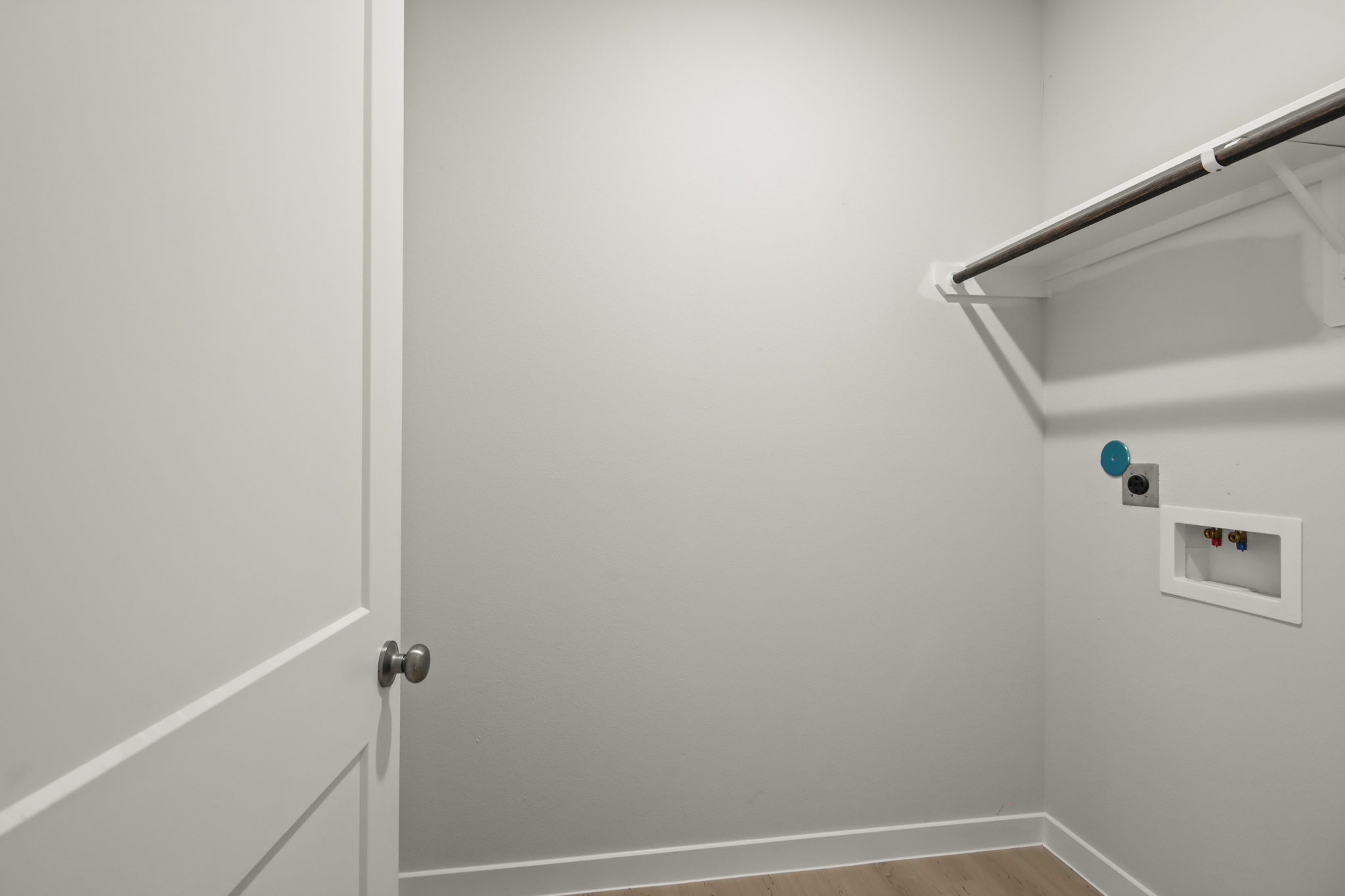 A white door with a light switch.