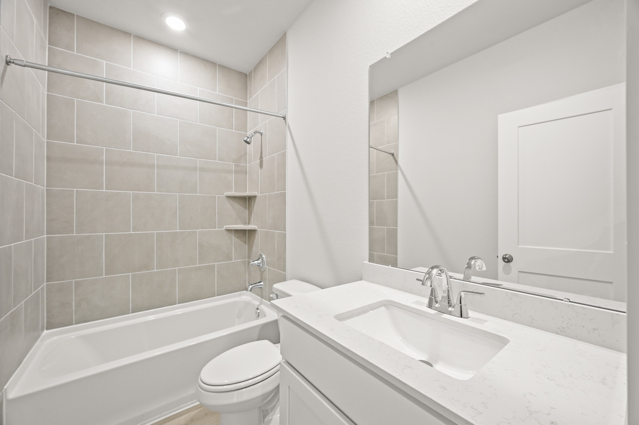 A bathroom with a tub sink and toilet.