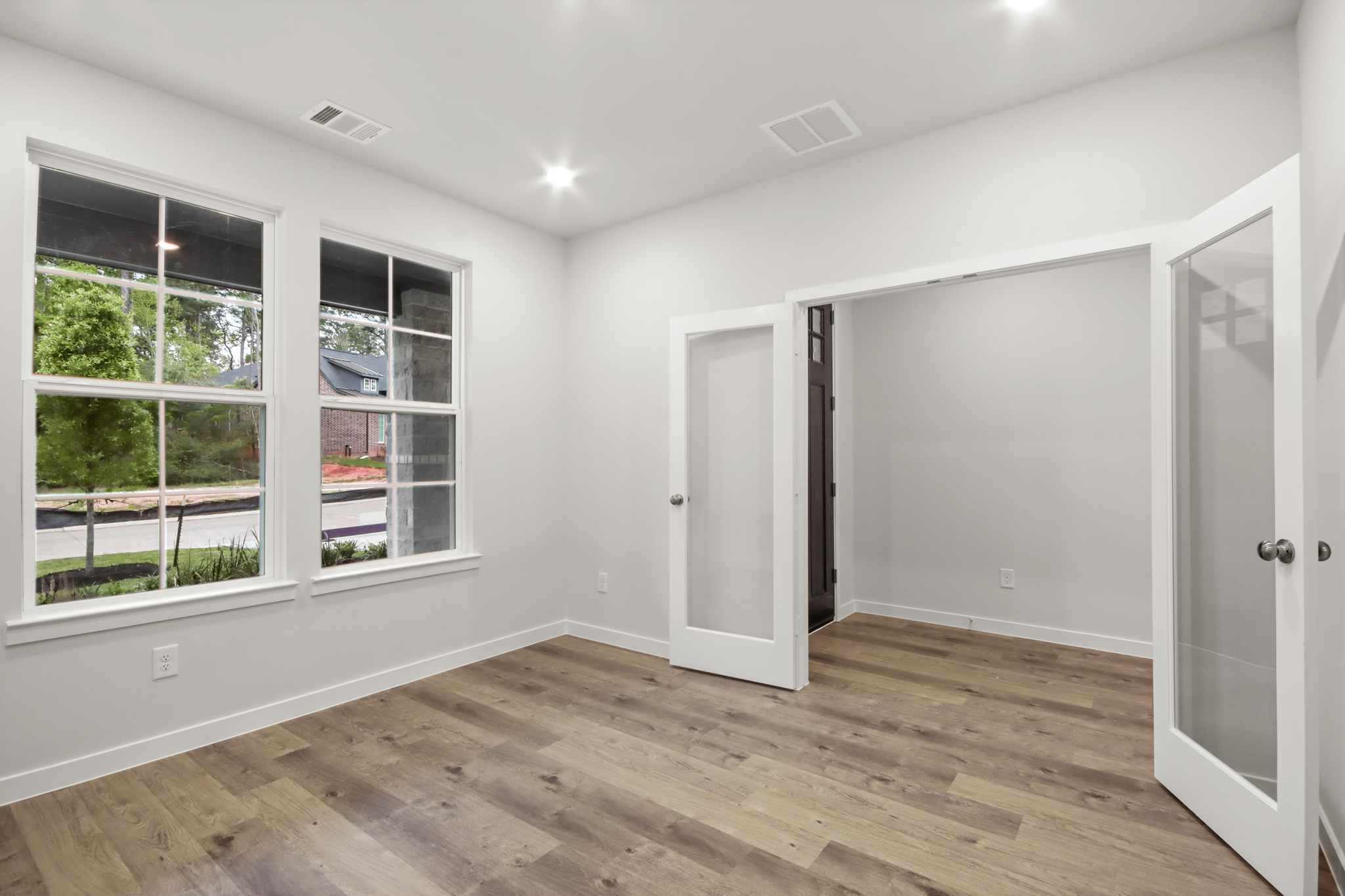 A room with white walls and windows.