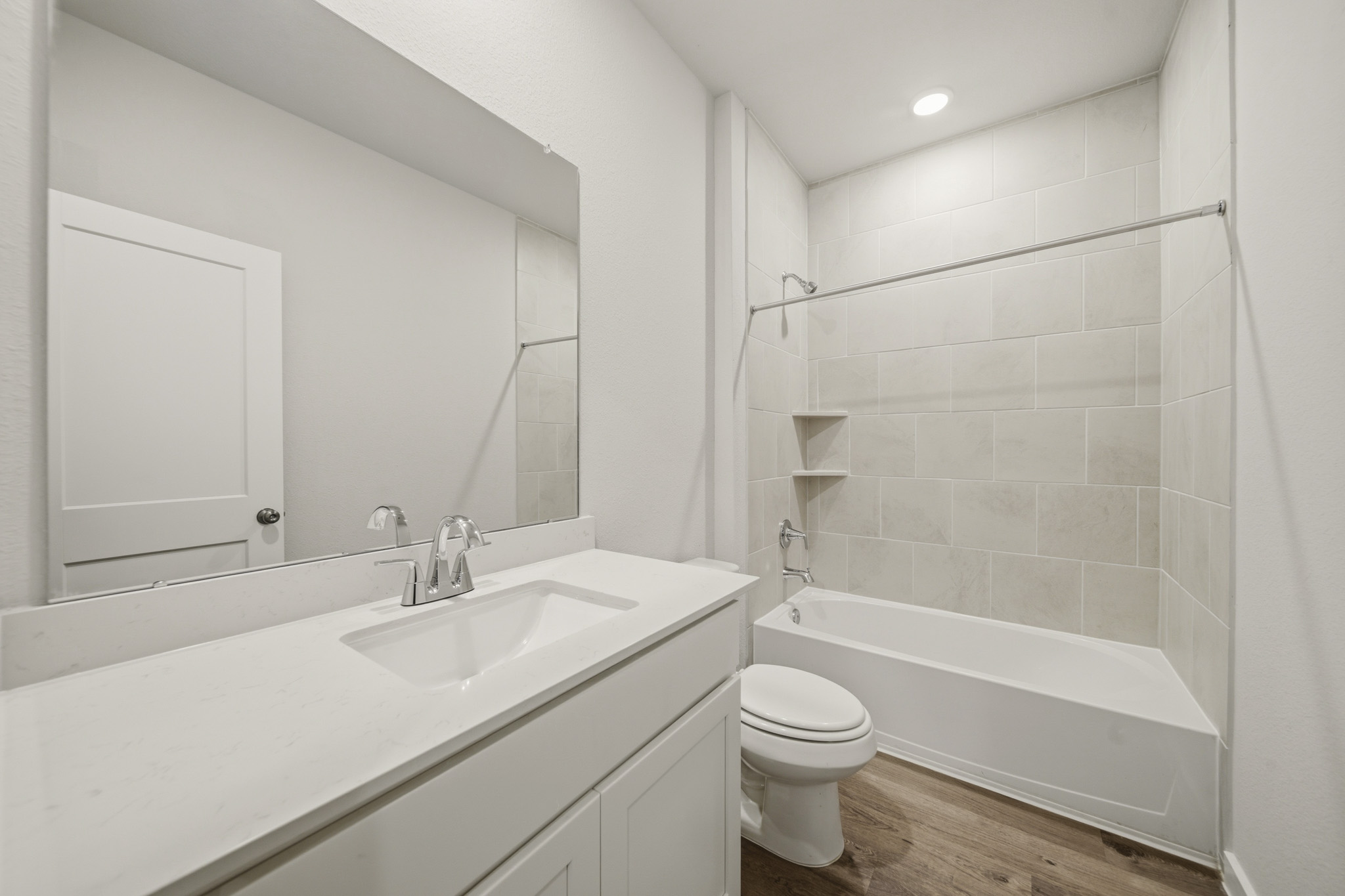 A bathroom with a tub sink and toilet.