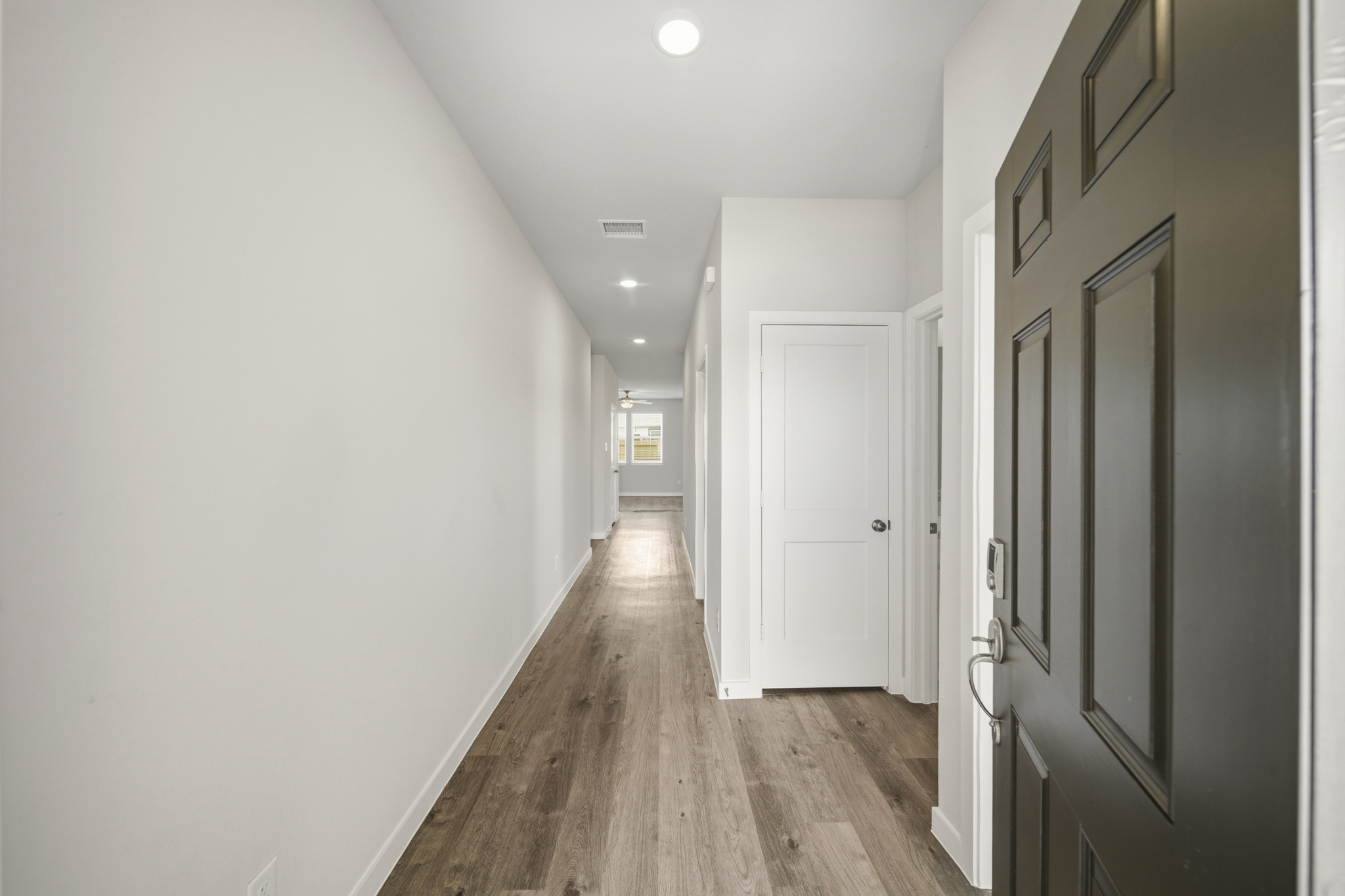 A hallway with white doors.