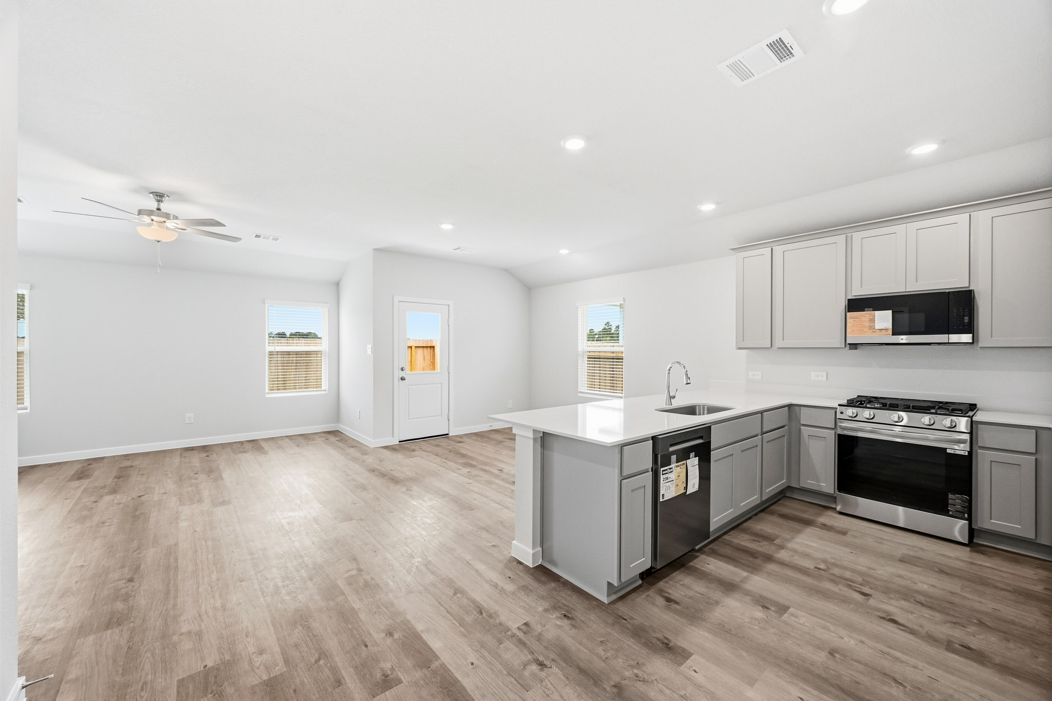 A kitchen with white cabinets.