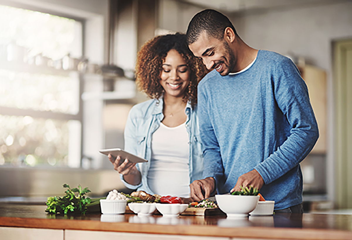 A man and a woman preparing food.