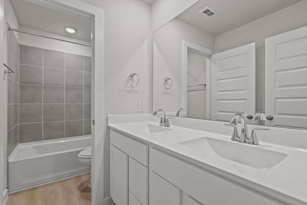 A bathroom with a tub sink and toilet.
