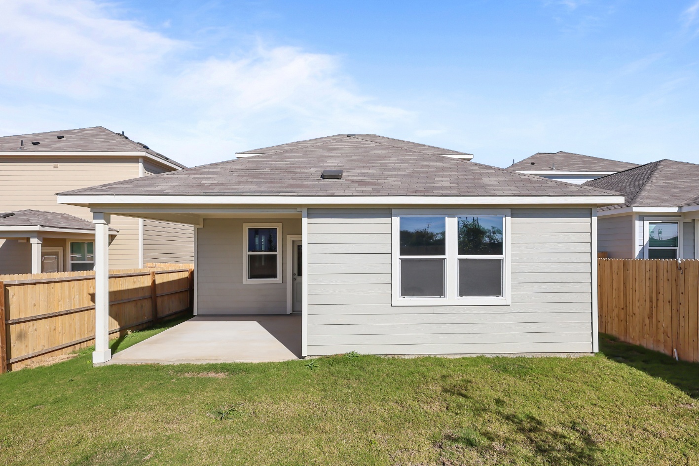 A house with a fence and grass.