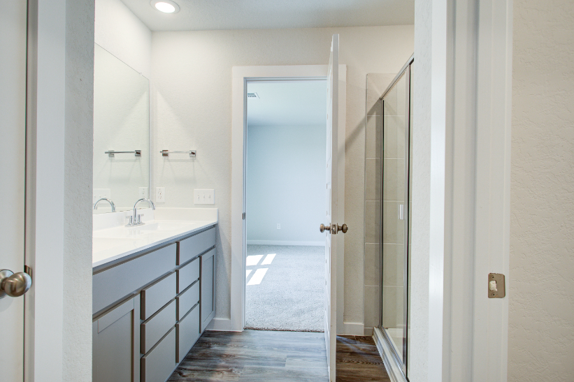 A bathroom with a glass door.