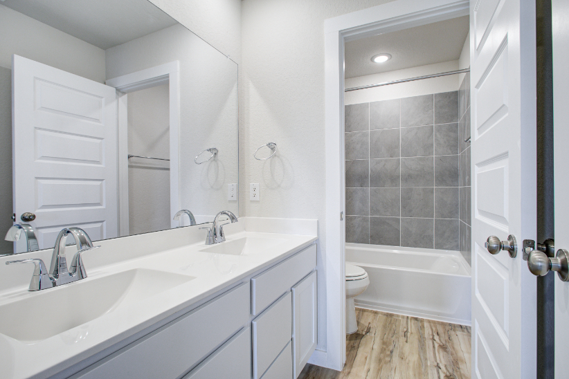 A bathroom with a tub sink and toilet.