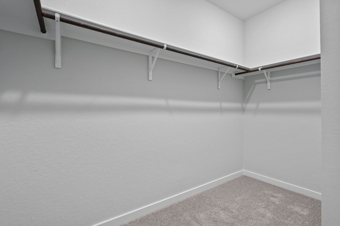 A white wall with a metal railing.