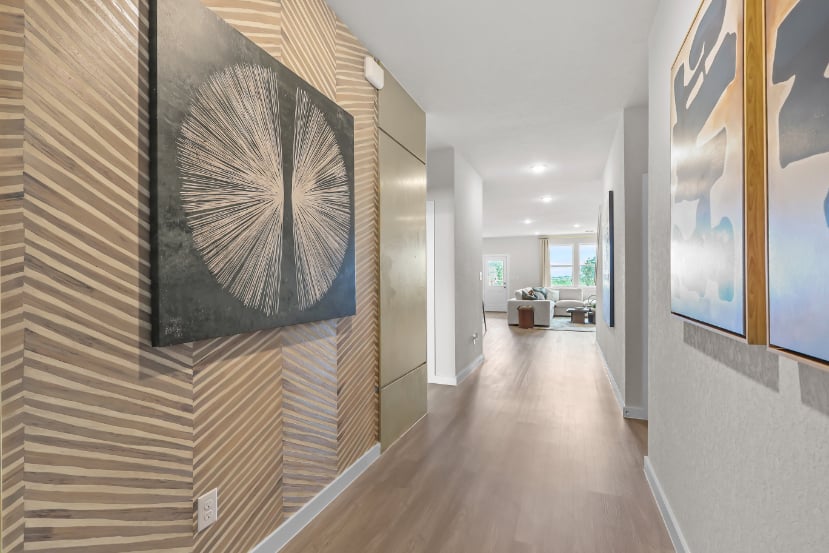 A long hallway with art on the walls.