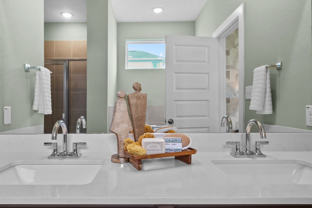 A bathroom with a large mirror.