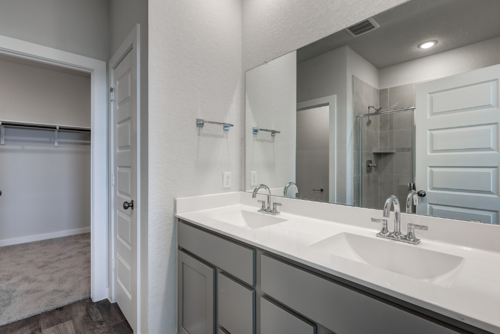 A bathroom with a large mirror.