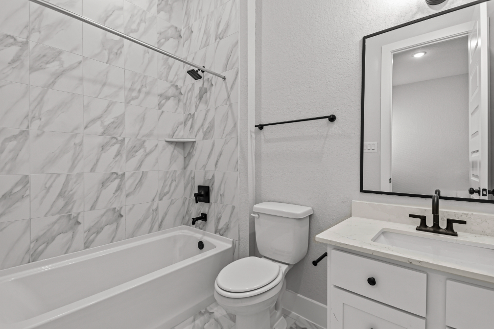 A bathroom with a shower and toilet.