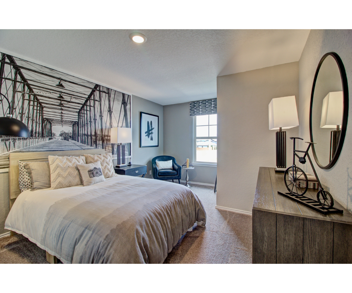 A bedroom with a bed and a mirror.