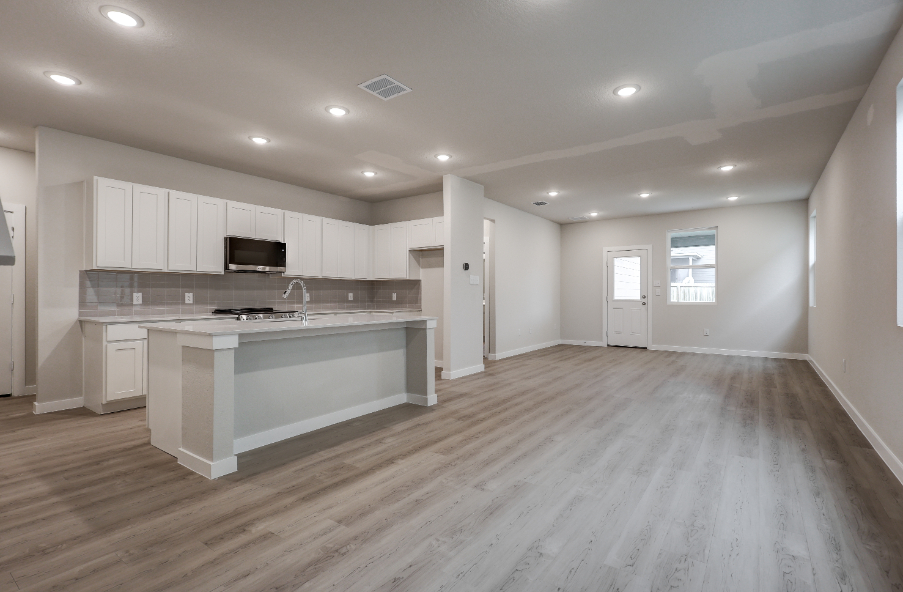 A large kitchen with white cabinets.