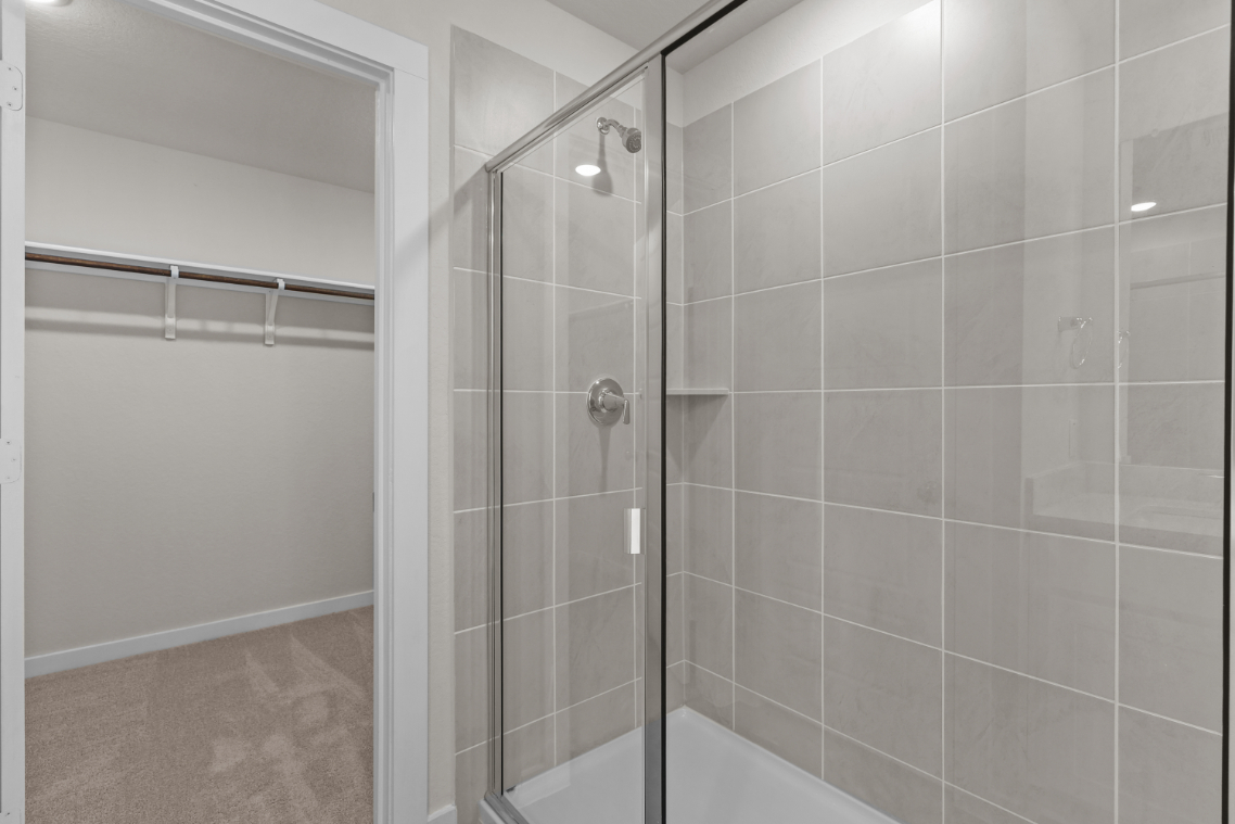 A shower with a glass door.