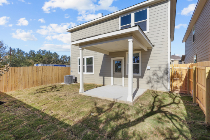 A house with a fence and grass.