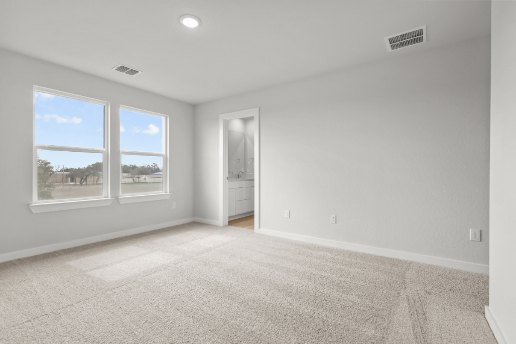 A room with a window and a carpet.