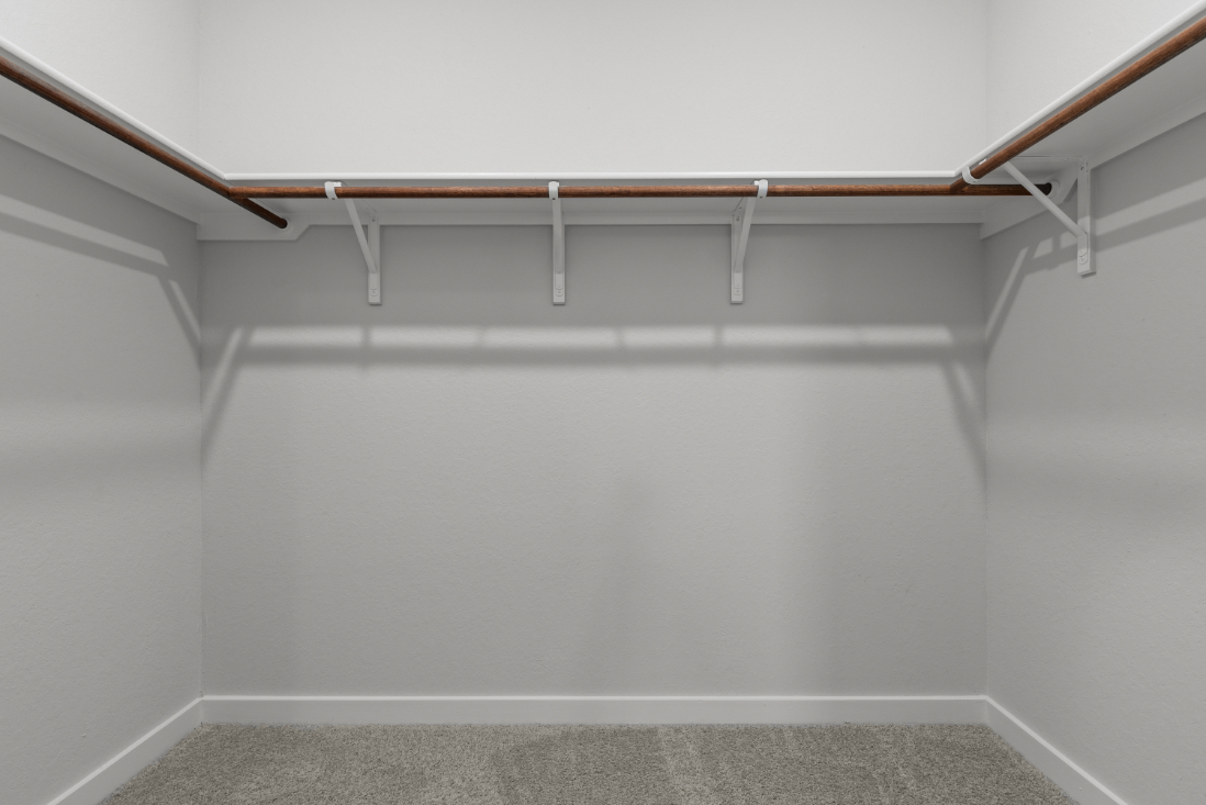 A white wall with a metal railing.