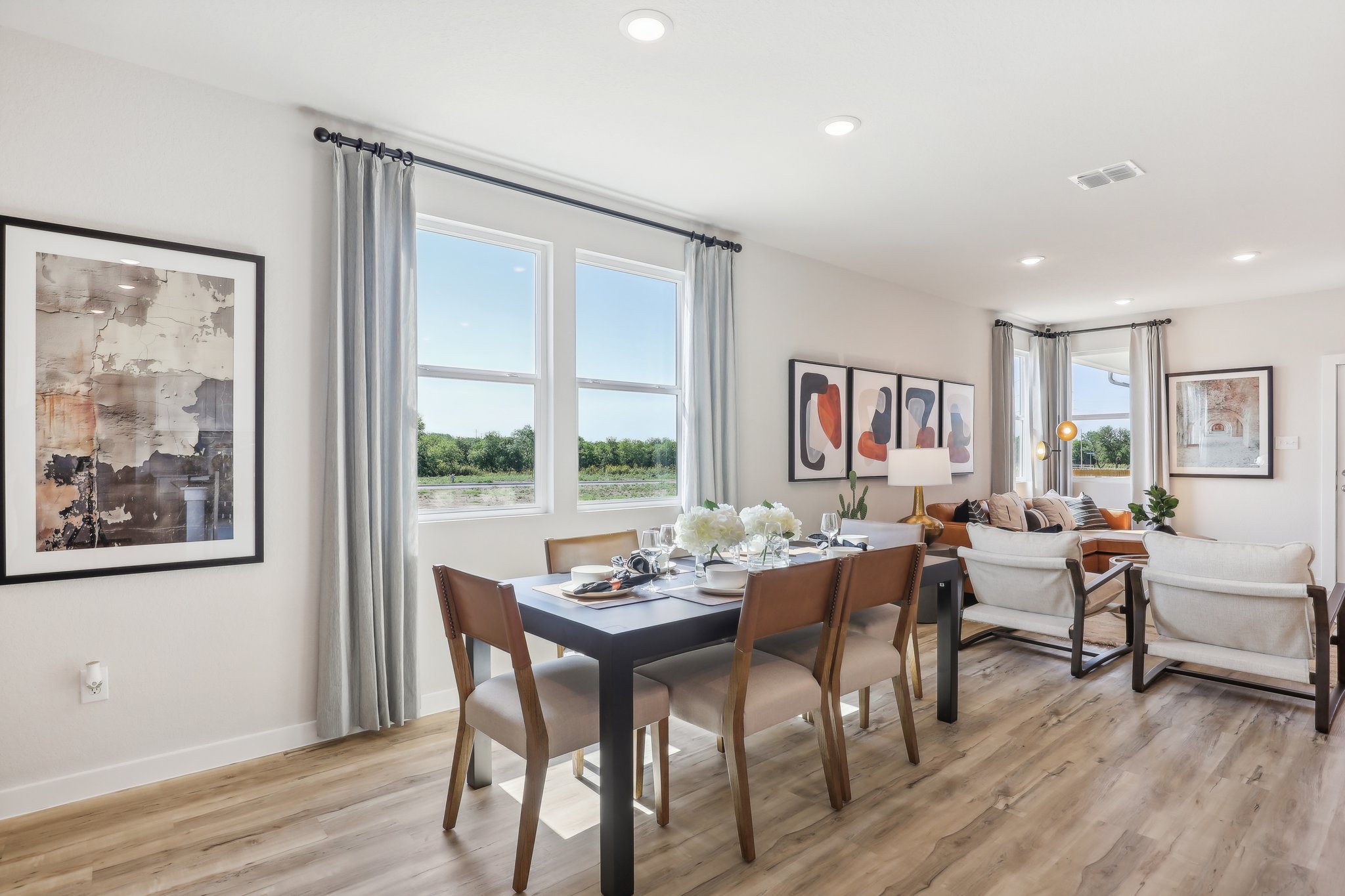 A dining room with a wood floor.