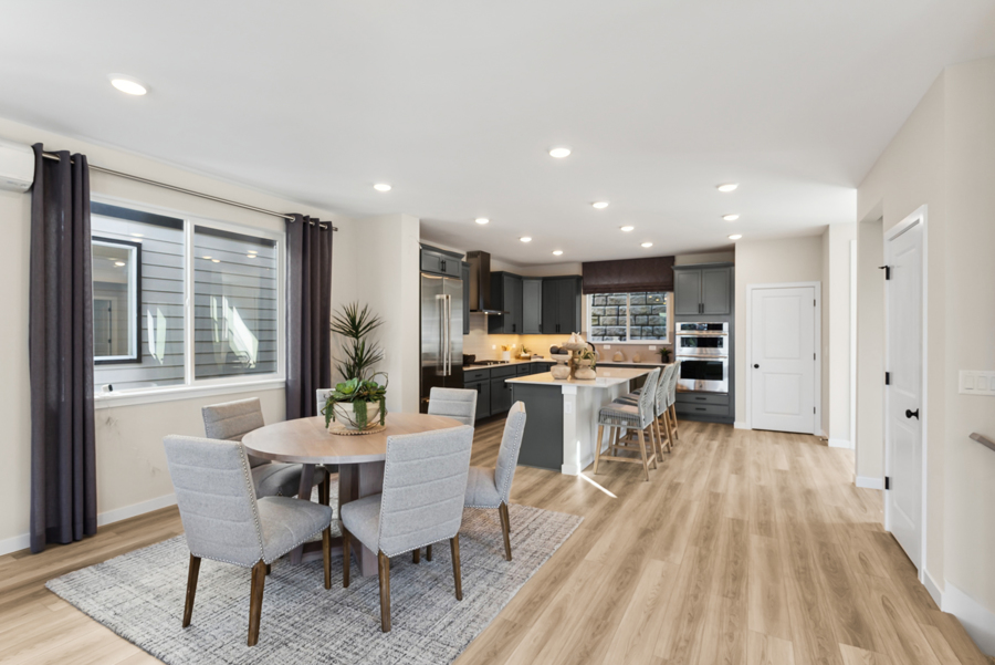 A large kitchen with a dining table.