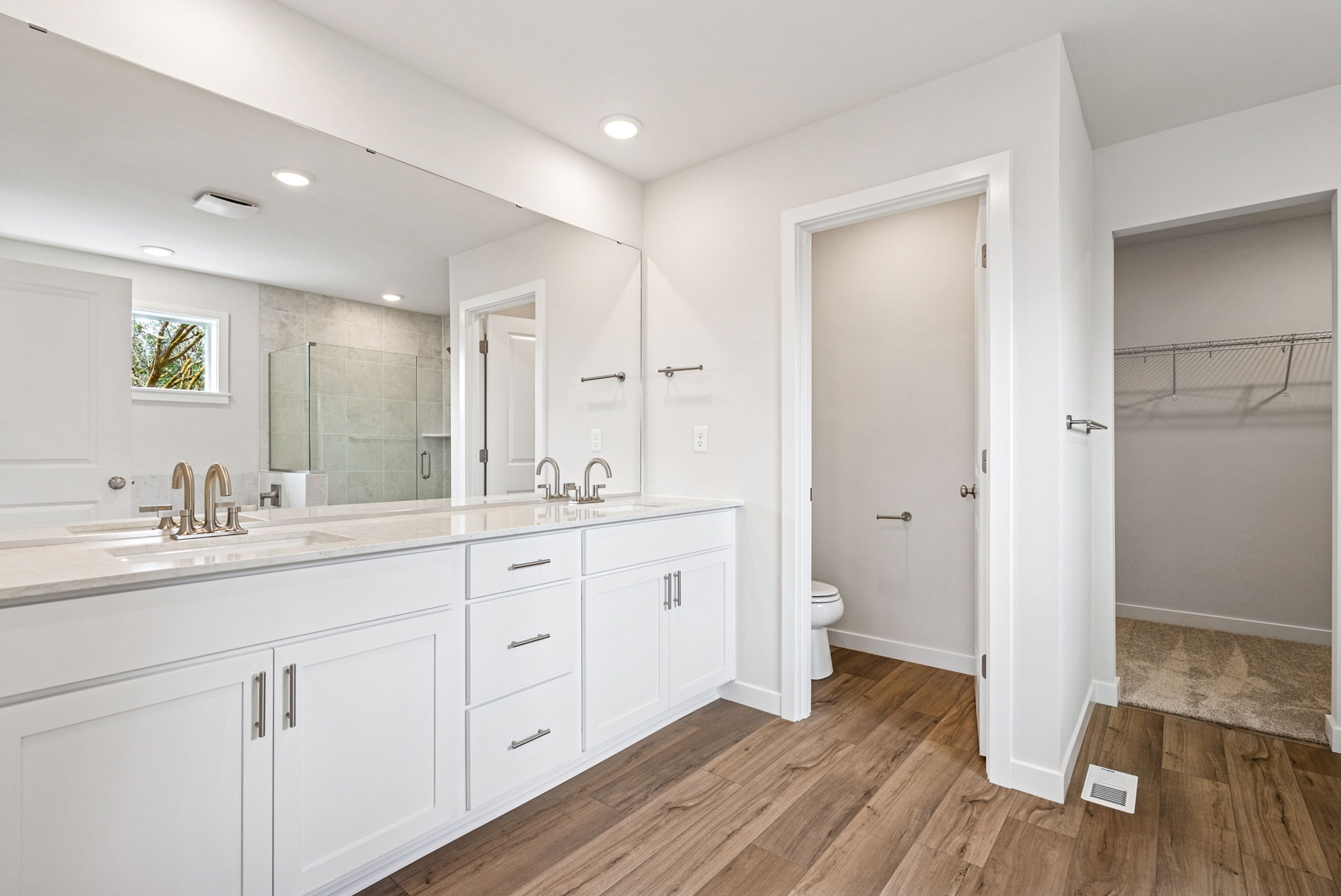 A bathroom with white cabinets.