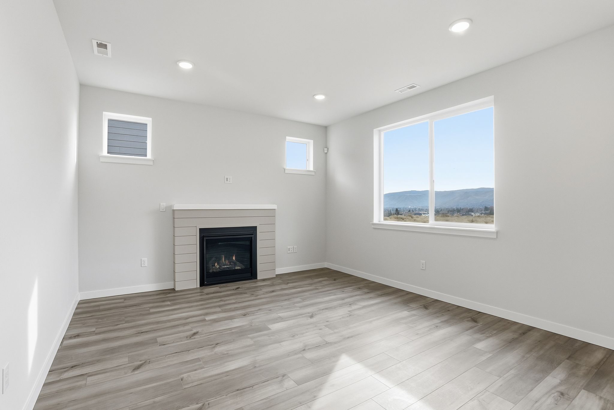 A room with a fireplace and a window.