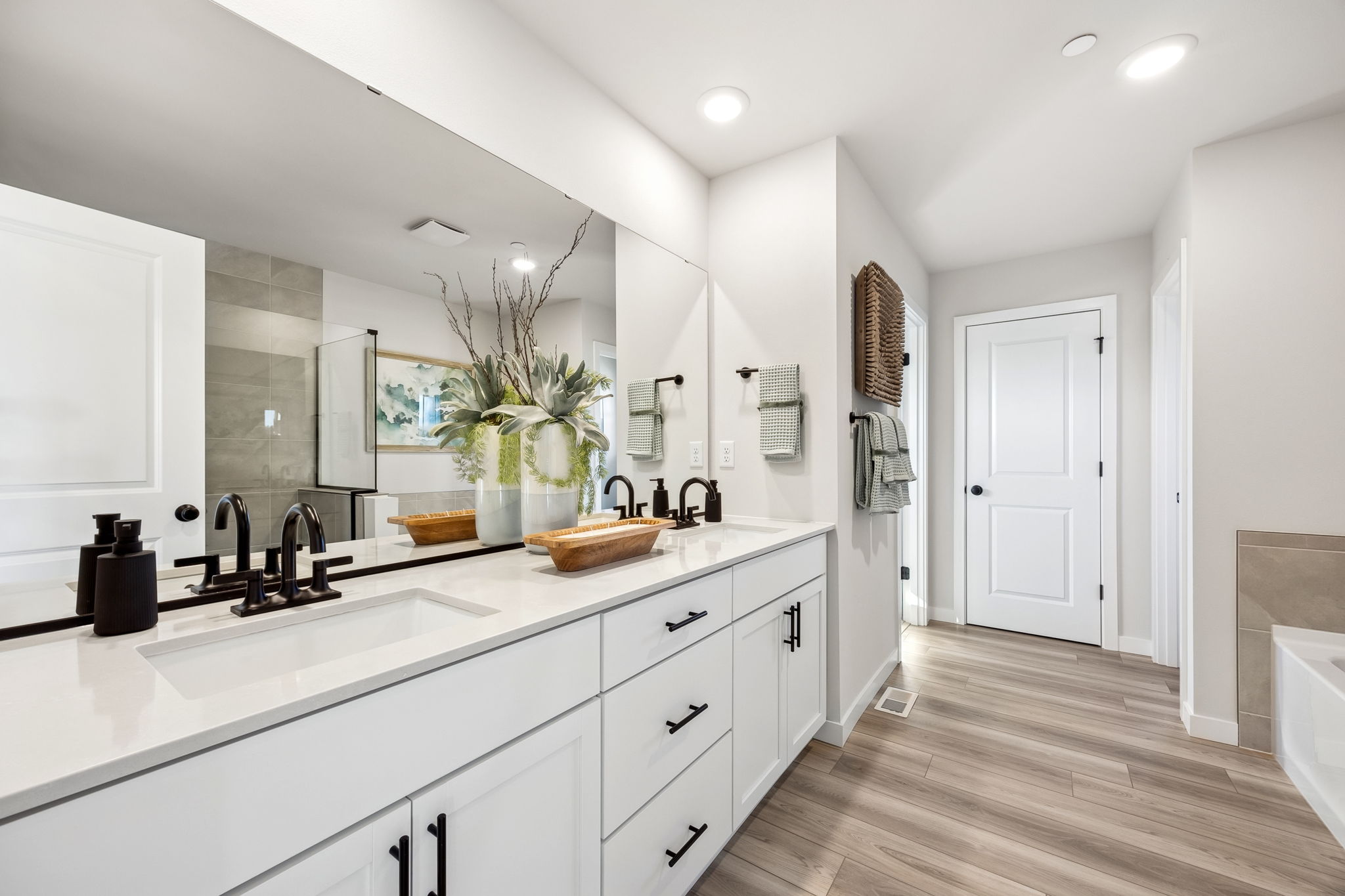 A bathroom with white cabinets.