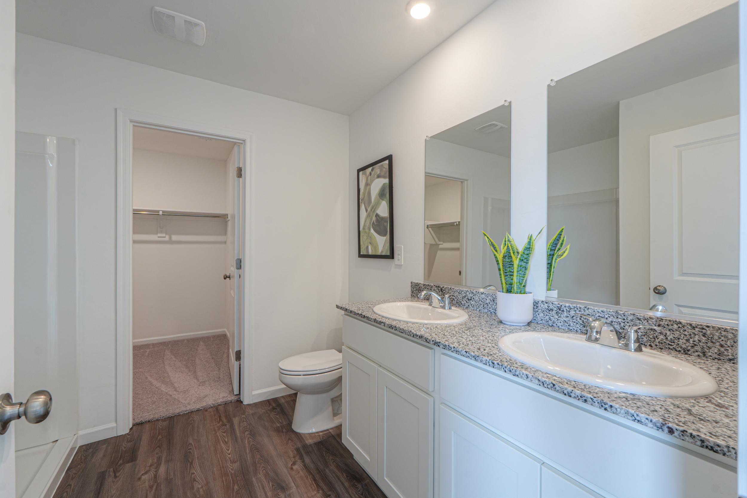 A bathroom with a sink toilet and a shower.