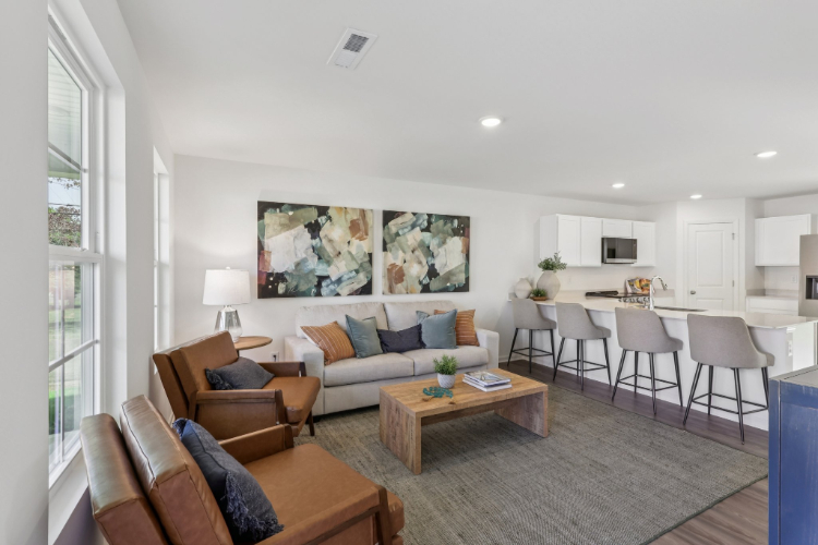 A living room with a large dining table and couches.