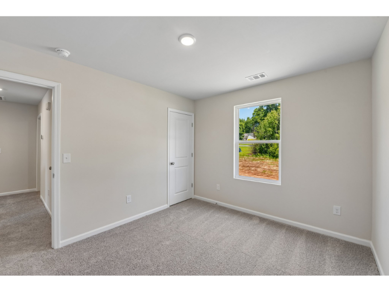 A room with a window and a door.