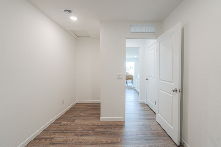 A hallway with white doors.