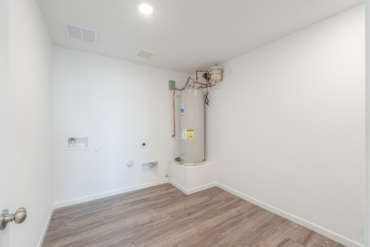 A room with a wood floor and white walls.